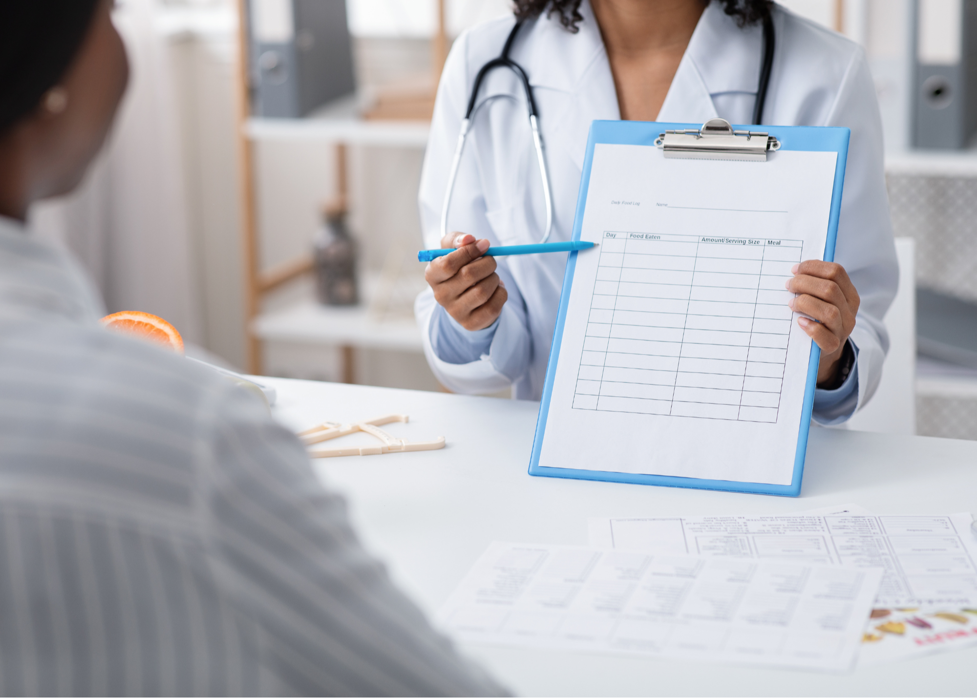 A healthcare provider presenting an insurance plan document to a patient, illustrating a discussion on healthcare coverage and benefits.