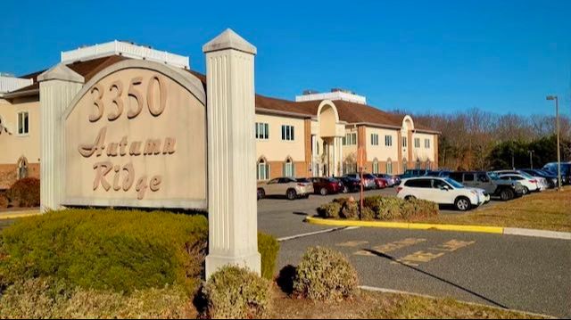 Exterior view of the 3350 Autumn Ridge office complex, home of YHealth in Building 1, showcasing the facility's entrance and parking area on a clear day.